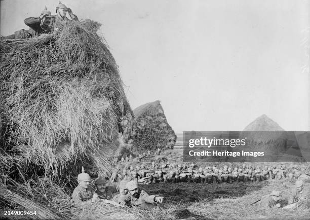 Germans in S.W. Belgium, between 1914 and circa 1915. German soldiers near large haystacks in Belgium during World War I. Creator: Bain News Service.