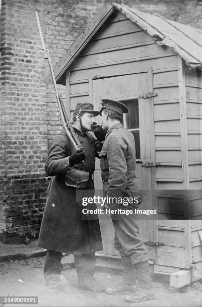 Feu, s'il vous plait, British and French at E´taples, between 1914 and circa 1915. British and French soldier lighting a cigarette at E´taples,...