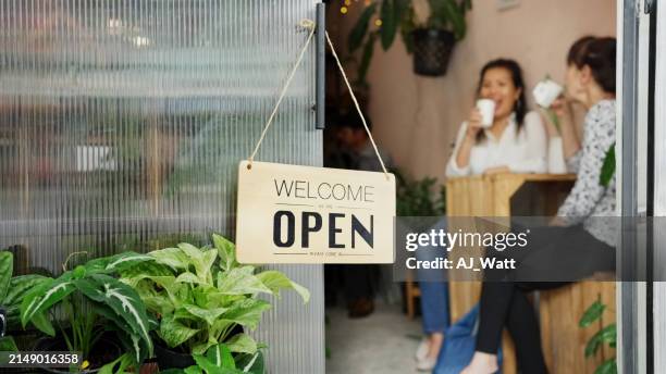 welcome board hanging on door of cafe - open sign stock pictures, royalty-free photos & images