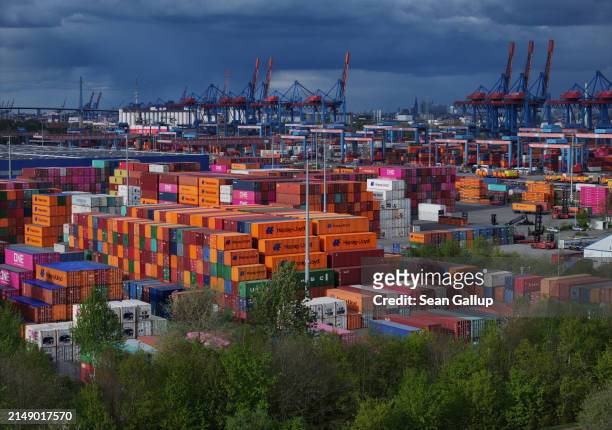 Shipping containers lie stacked at Hamburg Port on April 17, 2024 in Hamburg, Germany. The International Monetary Fund has reduced its prognosis for...