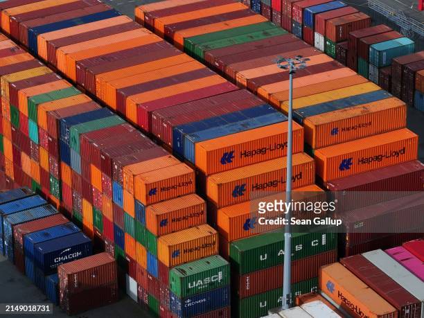 In this aerial view shipping containers, including from Hapag-Lloyd, lie stacked at Hamburg Port on April 17, 2024 in Hamburg, Germany. The...