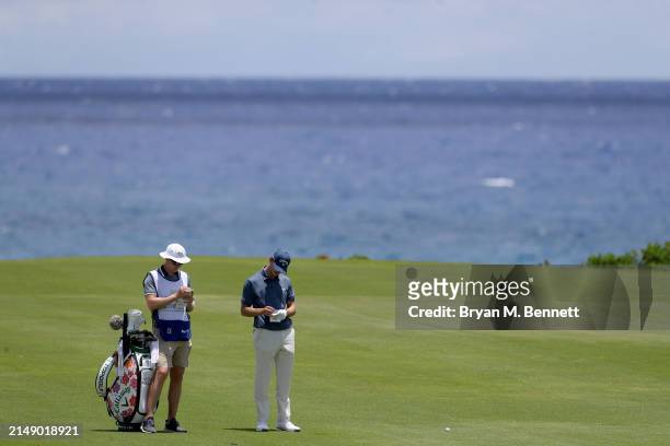 Nicolai Højgaard of Denmark talks with his caddie on the eighth hole during a practice round prior to the Corales Puntacana Championship at Puntacana...