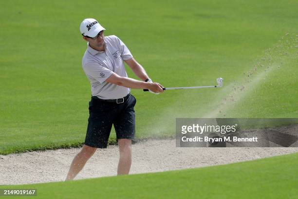 Russell Knox of Scotland plays a shot from a bunker on the 12th hole during a practice round prior to the Corales Puntacana Championship at Puntacana...