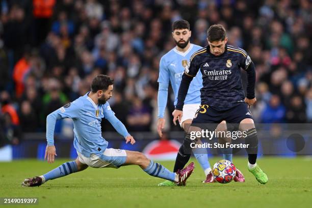 Federico Valverde of Real Madrid is challenged by Bernardo Silva of Manchester City during the UEFA Champions League quarter-final second leg match...