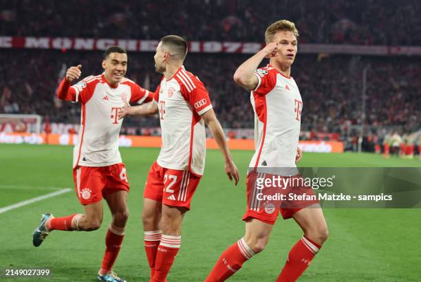 Joshua Kimmich of Bayern Muenchen celebrates as he scores the goal 1:0 with Jamal Musiala of Bayern Muenchen Raphael Guerreiro of Bayern Muenchen...