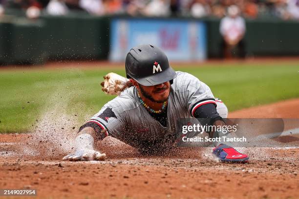 Austin Martin of the Minnesota Twins slides to score a run against the Baltimore Orioles during the seventh inning at Oriole Park at Camden Yards on...