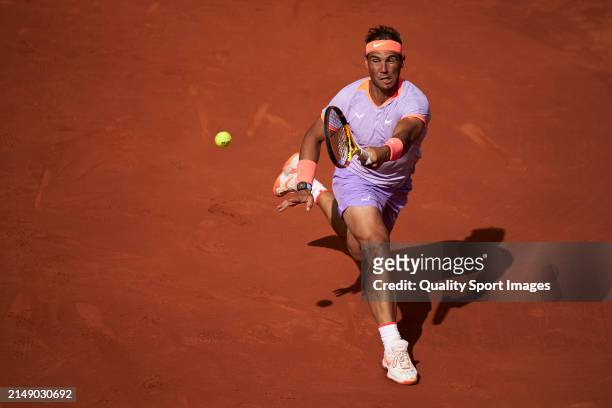 Rafael Nadal of Spain returns a ball against Alex de Minaur of Australia in the second round during day three of the Barcelona Open Banc Sabadell at...