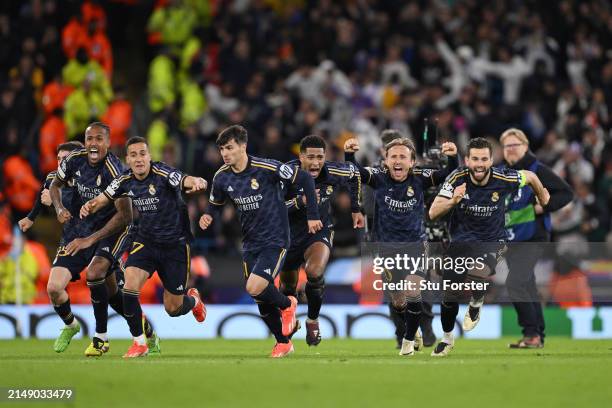 Real Madrid players celebrate after Antonio Ruediger of Real Madrid scored the sides winning penalty in the penalty shoot out during the UEFA...