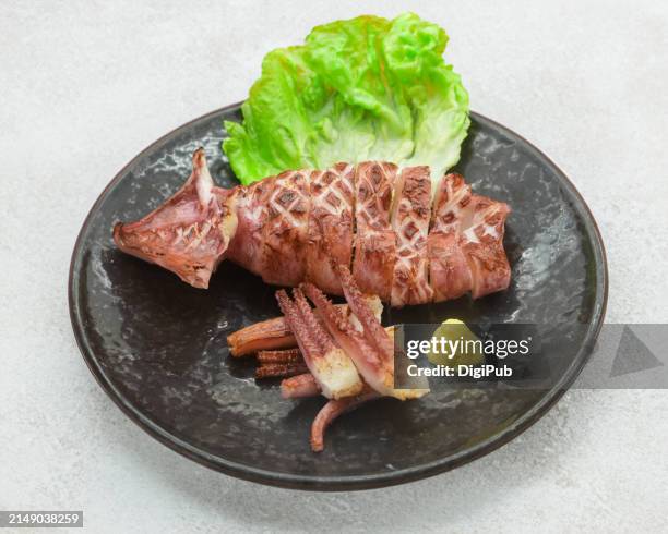 grilled splendor: a squid dish in repose - calamari stock pictures, royalty-free photos & images