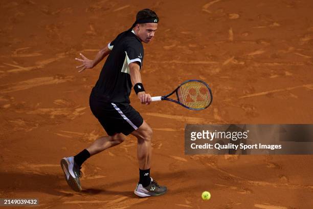 Daniel Altmaier of Germany returns a ball against Arthur Fils of France in the second round during day three of the Barcelona Open Banc Sabadell at...