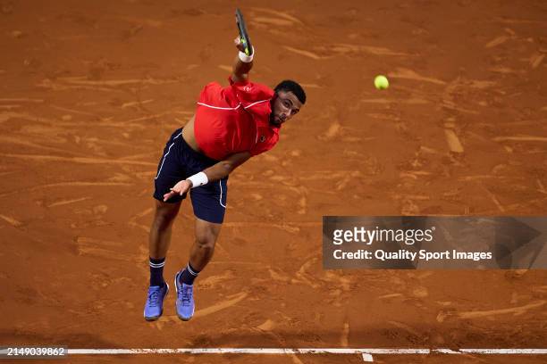 Arthur Fils of France serves against Daniel Altmaier of Germany in the second round during day three of the Barcelona Open Banc Sabadell at Real Club...