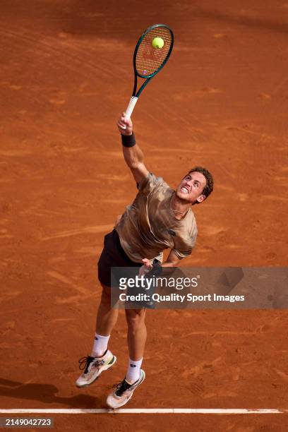 Roberto Carballes of Spain serves against Lorenzo Musetti of Italy in the second round during day three of the Barcelona Open Banc Sabadell at Real...