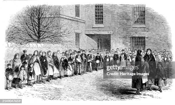 Operatives waiting for their breakfast in Mr. Chapman's courtyard, Mottram, near Manchester, 1862. Unemployed mill workers. Engraving of a photograph...