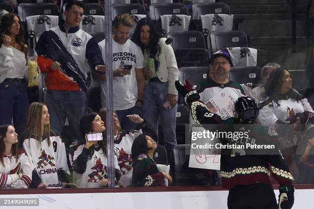 Clayton Keller of the Arizona Coyotes throws a puck to fans before the NHL game against the Edmonton Oilers at Mullett Arena on April 17, 2024 in...