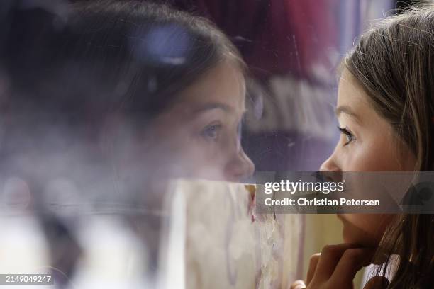 Young fan watches warm ups before the NHL game between the Edmonton Oilers and the Arizona Coyotes at Mullett Arena on April 17, 2024 in Tempe,...