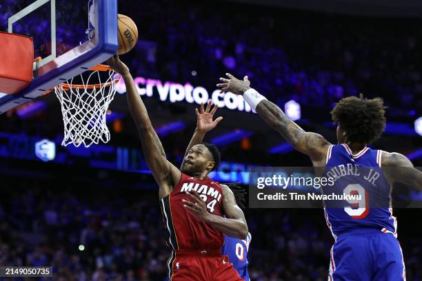 Haywood Highsmith of the Miami Heat shoots a lay up between Tyrese Maxey and Kelly Oubre Jr. #9 of the Philadelphia 76ers during the fourth quarter...