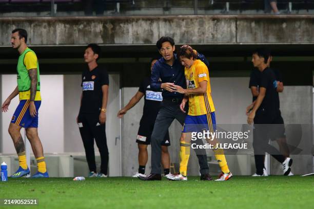 Naoki Ishihara of Vegalta Sendai celebrates with head coach Susumu Watanabe after scoring the team's second goal during the J.League J1 match between...