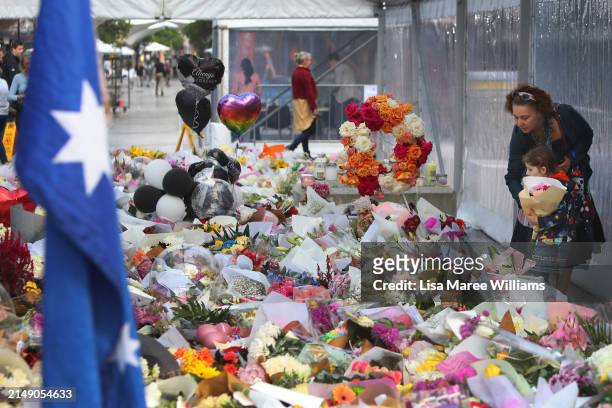 Members of the public lay flower tributes at the edge of Westfield Bondi Junction during a day of reflection on April 18, 2024 in Bondi Junction,...