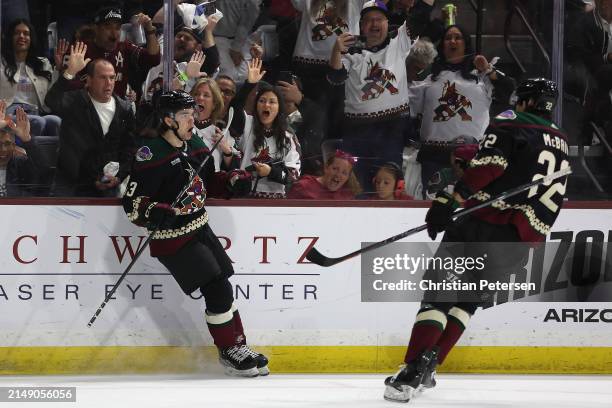 Matias Maccelli of the Arizona Coyotes celebrates with Jack McBain after scoring a goal against the Edmonton Oilers during the second period of the...