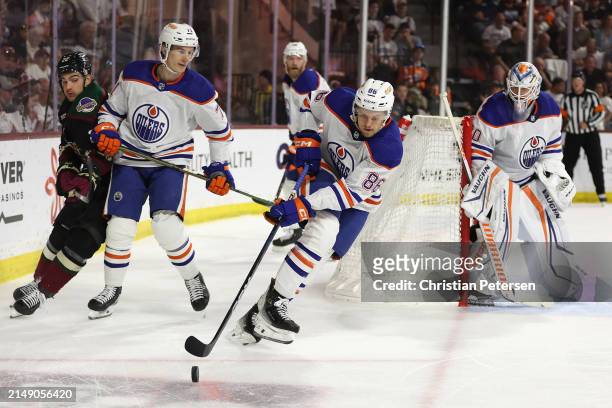 Philip Broberg of the Edmonton Oilers skates with the puck during the second period of the NHL game against the Arizona Coyotes at Mullett Arena on...