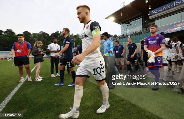 Captains Collin Martin of North Carolina FC and Jacob Evans of Carolina Core FC lead their teammates onto the field during the U.S. Open Cup third...