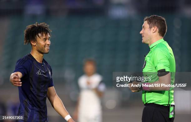 Referee Josiah Parke shows the yellow card to Jaden Servania of North Carolina FC during the U.S. Open Cup third round game between North Carolina FC...