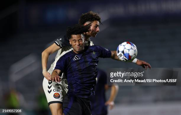 Jaden Servania of North Carolina FC and Christian Diaz of Carolina Core FC challenges for a header during the U.S. Open Cup third round game between...
