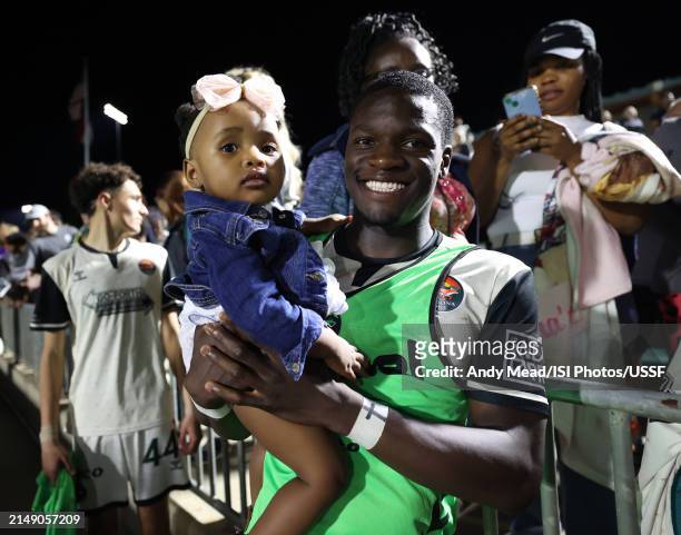 Yekeson Subah of Carolina Core FC holds his daughter after the U.S. Open Cup third round game between North Carolina FC and Carolina Core FC at...