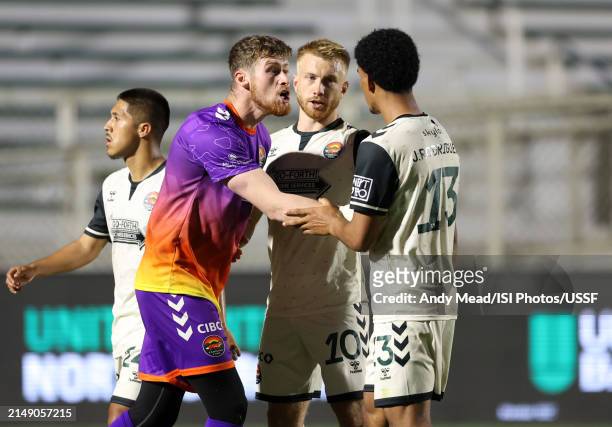 Alex Sutton and Jacob Evans push Joshua Rodriguez of Carolina Core FC away from a confrontation during the U.S. Open Cup third round game between...