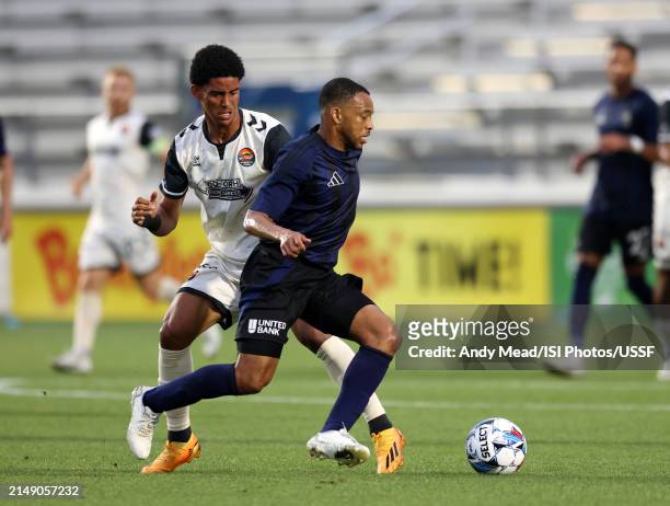Jacori Hayes of North Carolina FC pushes past Joshua Rodriguez of Carolina Core FC during the U.S. Open Cup third round game between North Carolina...