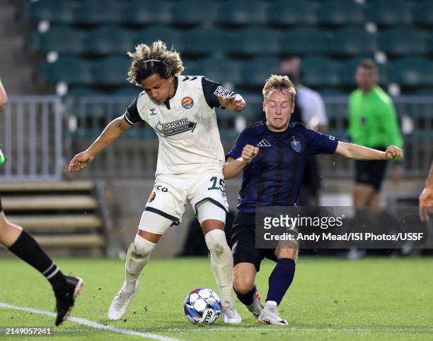 David Polanco of Carolina Core FC and Garrett McLaughlin of North Carolina FC challenge for the ball during the U.S. Open Cup third round game...