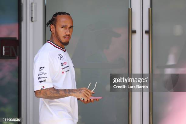 Lewis Hamilton of Great Britain and Mercedes looks on in the Paddock during previews ahead of the F1 Grand Prix of China at Shanghai International...