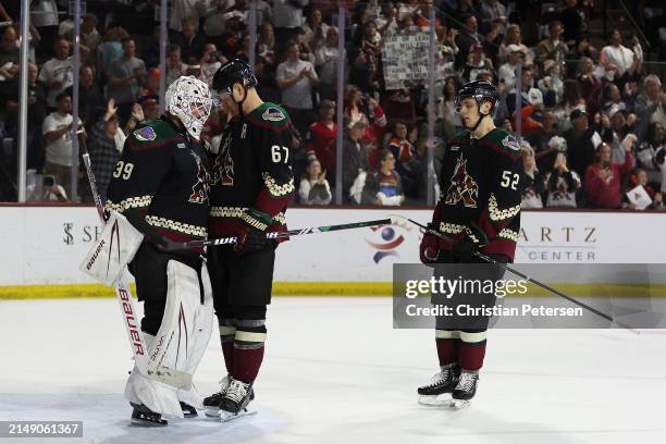 Goaltender Connor Ingram of the Arizona Coyotes is congratulated by Lawson Crouse and Vladislav Kolyachonok after defeating the Edmonton Oilers in...