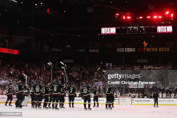 The Arizona Coyotes salute the fans after defeating the Edmonton Oilers in the NHL game at Mullett Arena on April 17, 2024 in Tempe, Arizona. The...