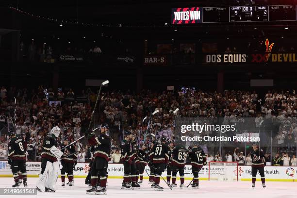 The Arizona Coyotes salute the fans after defeating the Edmonton Oilers in the NHL game at Mullett Arena on April 17, 2024 in Tempe, Arizona. The...