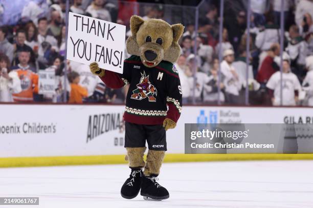 The Arizona Coyotes mascot, "Howler" holds up a sign reading "thank you fans" following the NHL game against the Edmonton Oilers at Mullett Arena on...