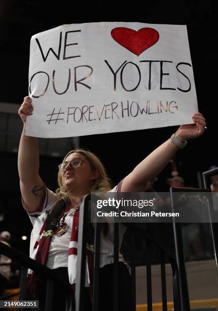 Fan of the Arizona Coyotes holds up a sign reading "we love our yotes" following the NHL game against the Edmonton Oilers at Mullett Arena on April...