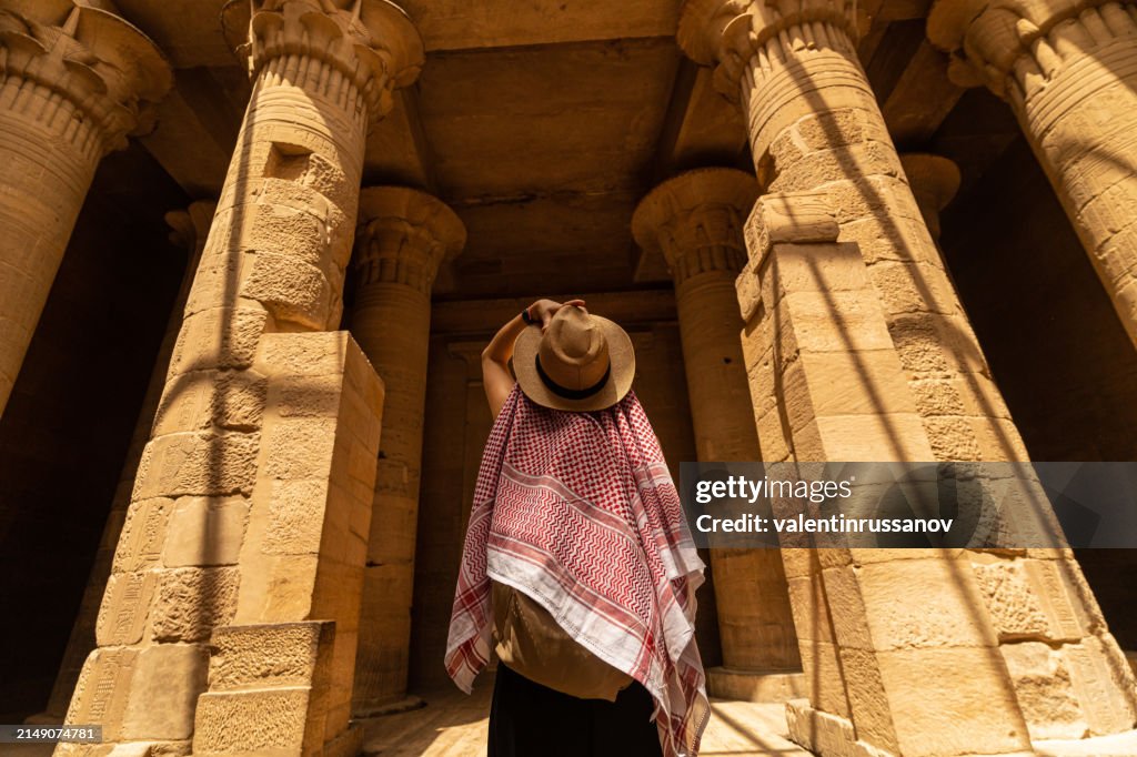 Woman walking in Temple of Philae aka Temple of Isis in Aswan Egypt,Agilkia Island