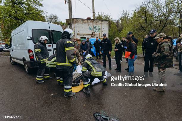 Rescuers put dead body in white body bag on the street after Russian missile attack on April 17, 2024 in Chernihiv, Ukraine. Russian forces launched...