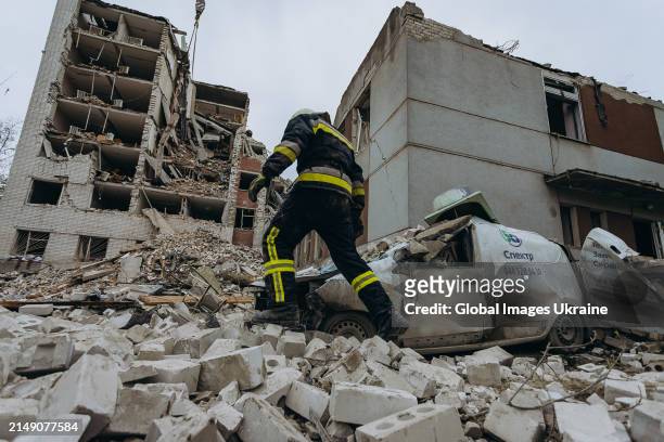 Rescuers conduct search and rescue operation at object of social infrastructure destroyed as result of Russian missile attack on April 17, 2024 in...