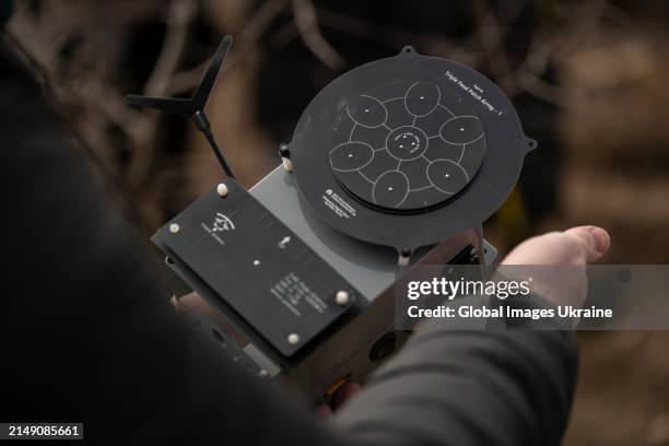 Man shows EW devices during a presentation on March 19, 2024 in Ukraine. During the 'Protect Warrior from Drone' event, Kvertus showed off electronic...