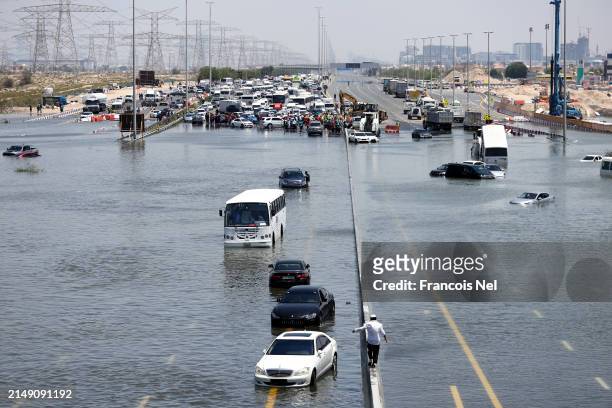 General view of abandoned vehicles on a flooded highway can be seen on April 18, 2024 in Dubai, United Arab Emirates. Atypically heavy rains in the...
