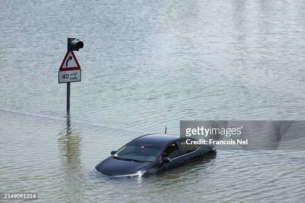 An abandoned vehicle is seen on April 18, 2024 in Dubai, United Arab Emirates. Atypically heavy rains in the UAE on Monday and Tuesday caused...
