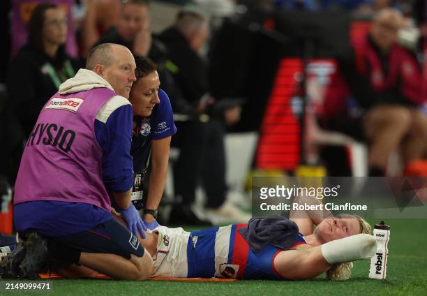 Cody Weightman of the Bulldogs looks on as he receives treatment on the sidelines during the round six AFL match between St Kilda Saints and Western...