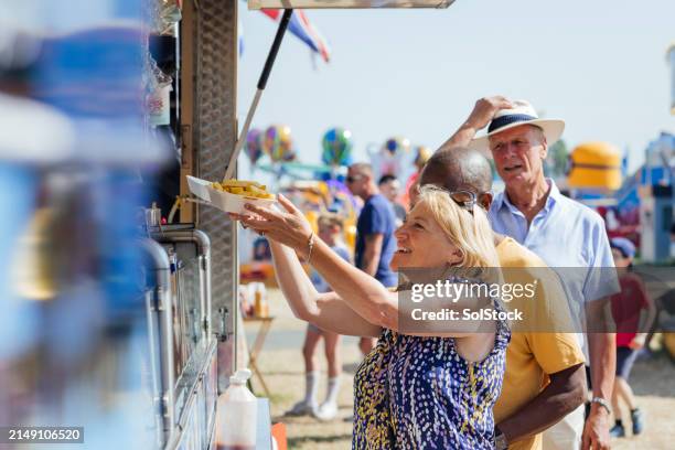 visiting the food truck at the fair - fairground stall stock pictures, royalty-free photos & images