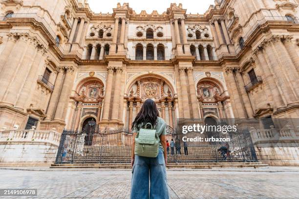 young woman enjoying the view of a cathedral in málaga in spain - provincie málaga stockfoto's en -beelden