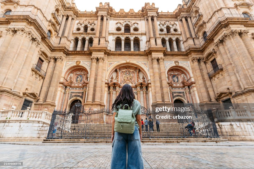 Young Woman Enjoying The View Of A Cathedral In Málaga In Spain