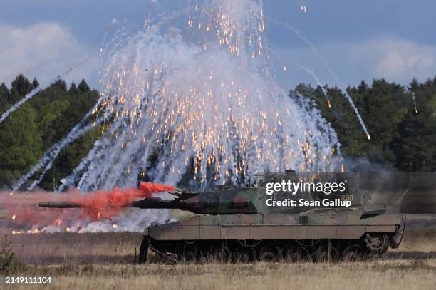 Leopard 2 A6 main battle tank of the Bundeswehr, the German armed forces, releases flares and smoke during the "National Guardian" military exercise...