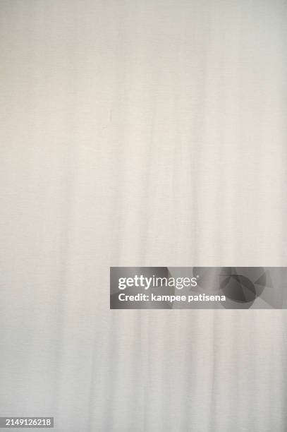 a whtie fabric with a pattern of lines and dots. the fabric is soft and smooth to the touch - draped stock pictures, royalty-free photos & images