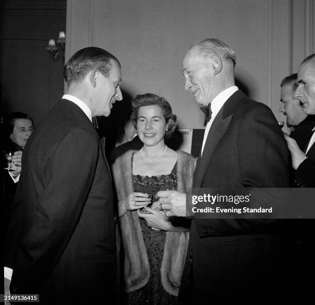 Bookseller Christina Foyle standing between Mr John Lawrence, left, and Mr Crawley at a literary function, London, April 9th 1957.